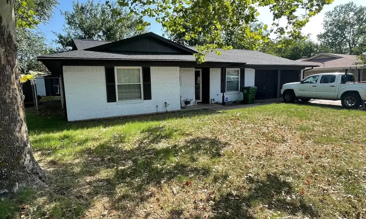 Professional roofing crew working on a residential roof in Whitehouse